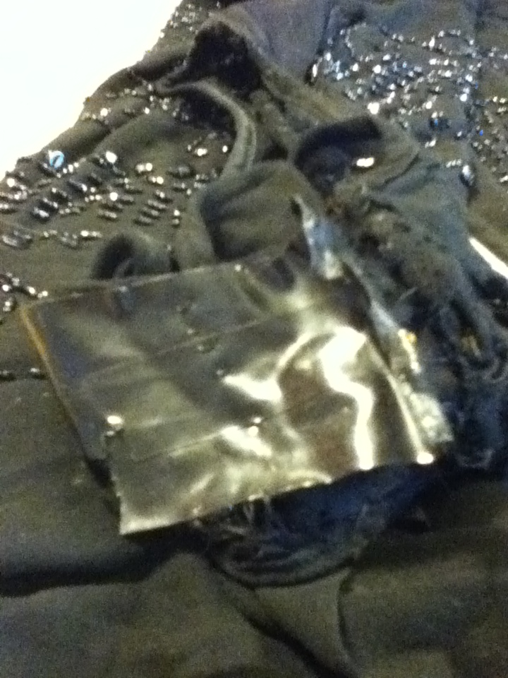 Photograph of dress held together with electrical tape